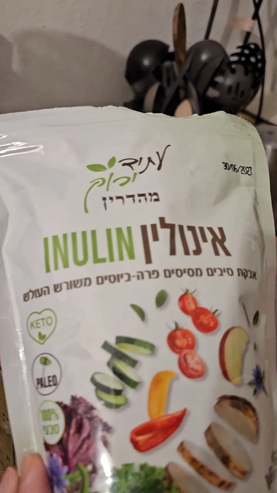 A bag of inulin prebiotic fiber held up in the kitchen